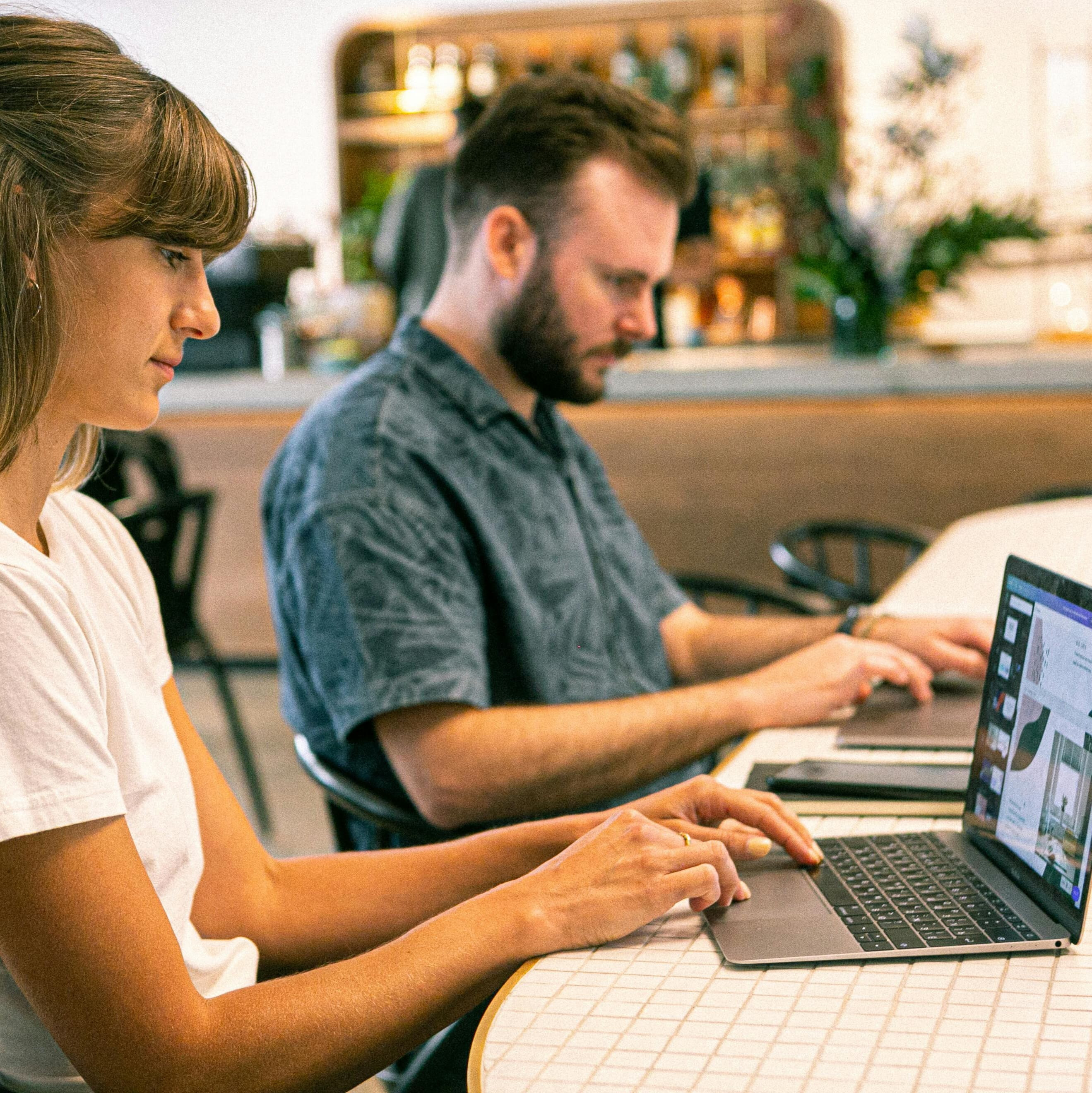 Two people using computers